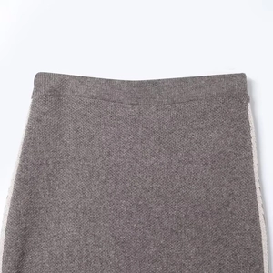 Detailed view of taupe knit midi skirt with white side stripes and elastic waist texture