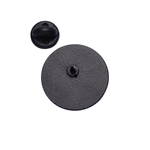 Macro detail of the back of a black enamel earth pin with a rubber clutch fastener