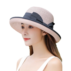 Women's foldable summer straw sun hat with wide brim and black ribbon bow detail