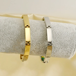18K gold and silver stainless steel beaded link bracelets displayed on a velvet jewelry stand