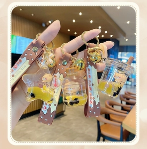 Close-up of star and cup shaped bubble tea keychains with bear liquid and sand detail