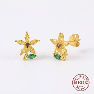 Macro shot of 925 sterling silver flower earrings with yellow and green crystals