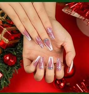 Detailed view of Christmas press-on nails with snowflakes and rhinestones decoration