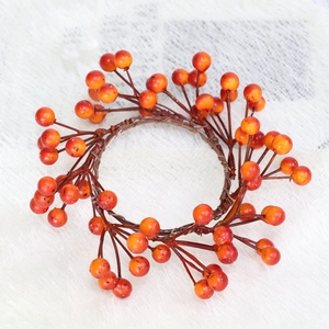 Macro shot of orange autumn berry candle ring with realistic texture and woven branch detail