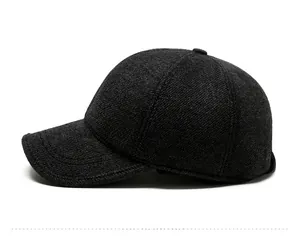 Detail of dark grey wool baseball cap with metal SPORT logo and thick winter texture