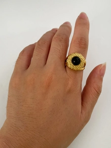 Detailed shot of 18K gold stainless steel ring with black stone and beaded texture
