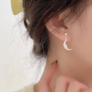 Elegant 925 sterling silver moon stud earrings worn for a delicate side profile fashion look
