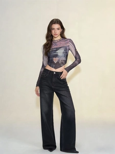 High-waisted wide-leg denim jeans paired with long-sleeve mesh top on a model