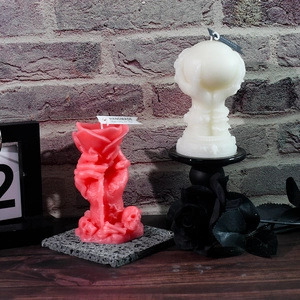 Gothic skull hand holding a rose candle with red and white resin skeleton base