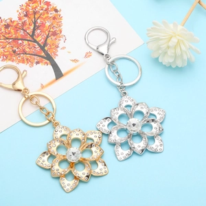 Sparkling floral rhinestone keychain set in gold and silver plating with crystal petals