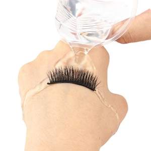 Waterproof test of black self-adhesive false eyelashes with water pouring on a hand