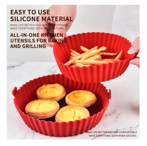 Detail of red silicone air fryer liners being used for baking fries and egg tarts