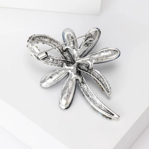 Elegant silver dragonfly brooch with crystal wings and intricate metal texture