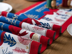 Macro shot of jacquard Christmas table runner featuring reindeer and festive patterns