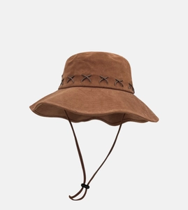 Close-up of brown sun hat with decorative X-shaped stitching and adjustable drawstring