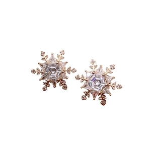 Gold plated snowflake stud earrings with hexagonal cubic zirconia on white background