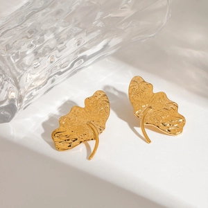 Detail showing the hammered texture and golden leaf design of these titanium steel earrings