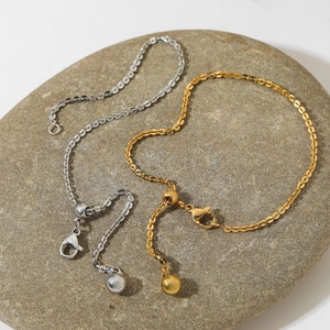 Minimalist adjustable stainless steel ball bracelet in gold and silver finish on stone