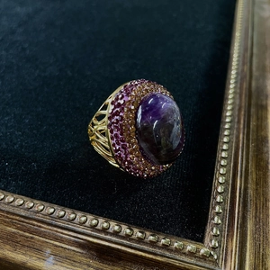 Detailed macro of vintage cocktail ring with purple oval amethyst and pave gemstones