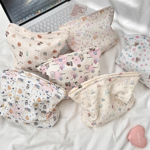 Detailed seersucker makeup bags with embossed cartoon patterns and soft texture