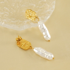 Detail showing gold hammered finish rectangular earrings with star motif and baroque pearl