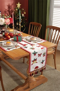 Detailed Christmas table runner featuring red snowflake motifs and festive white tassels