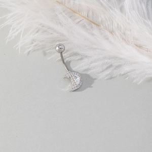 Silver crescent moon belly button ring with sparkling cubic zirconia on light background
