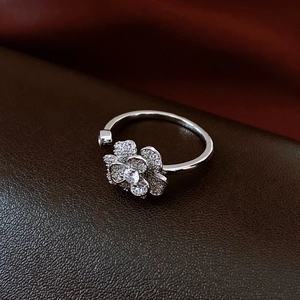 Detailed macro shot of silver flower open ring featuring shimmering white zircon petals