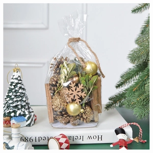 Detail of DIY Christmas pine cone kit with cinnamon sticks and golden ornaments