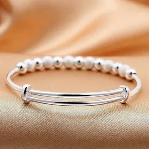 Silver beaded bangle bracelet with adjustable sliding closure and matte finish beads