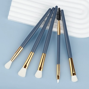 Professional 5-piece blue eye makeup brush set with gold ferrules on blue background