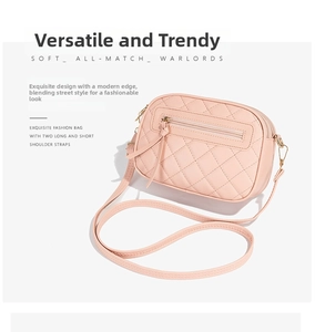 Detail view of pink quilted crossbody bag showing side structure and PU leather texture