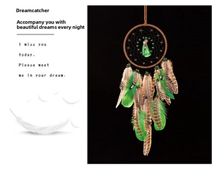 Close-up of brown dream catcher with natural green feathers and intricate beadwork details