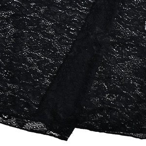 Close-up of black lace fabric with floral embroidery and semi-sheer mesh texture