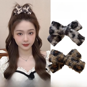 Détail de la pince à cheveux noeud en peluche léopard montrant la texture douce du tissu