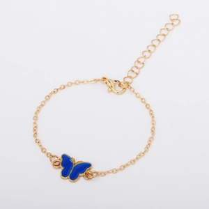 Minimalist gold chain bracelet with blue enamel butterfly charm and adjustable lobster clasp