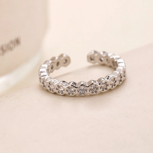 Macro detail of silver adjustable honeycomb ring with sparkling cubic zirconia inlay