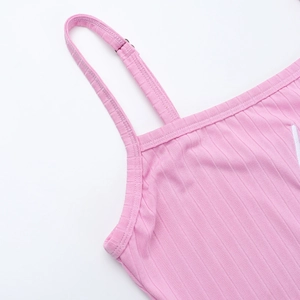 Detail of pink ribbed knit camisole showing shoulder strap stitching and fabric texture