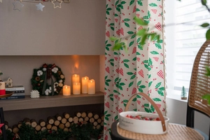 Detailed view of Christmas curtains with green leaves, red hearts, and beige tassels decoration