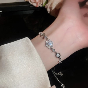 Detailed view of a silver snowflake pendant bracelet with sparkling zircon stones