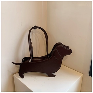 Detailed view of the dachshund shaped tote bag in coffee brown matte leather texture