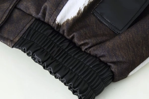 Detail of animal print fabric and black leather patch on casual short jacket