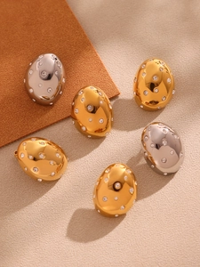 Close-up of sparkling Czech rhinestone oval earrings in gold and silver finishes