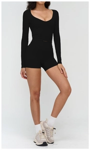 Detailed view of women's black long-sleeve crop top and high-waisted gym shorts set