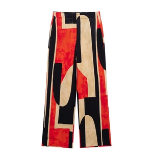 Women's two-piece set featuring wide-leg pants with red and black abstract geometric patterns
