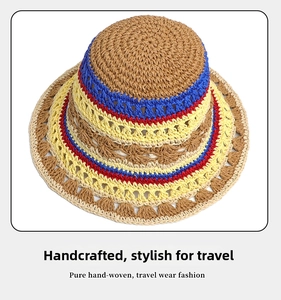 Close-up of handmade hollow flower pattern on a colorful striped knit bucket hat