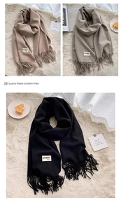Close-up of soft tassel scarf edges in camel, grey and black with detailed material tags