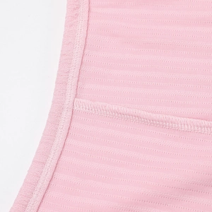 Macro shot of pink ribbed knit fabric with breathable mesh and detailed stitching detail