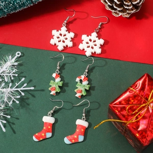 Christmas earrings set featuring snowflake, candy cane and stocking on festive background