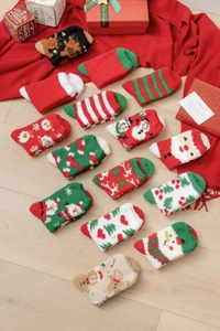 Detailed flat lay of thick coral fleece Christmas socks in red and festive patterns